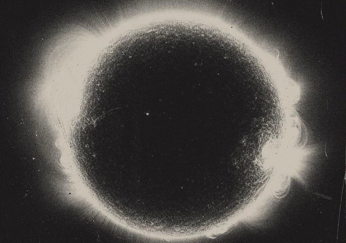 Solar eclipse with a dark central disk and bright outer ring.